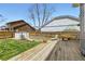 This backyard features a deck, lawn, a storage shed, and a wood fence that encloses the entire yard at 3803 Dyanna Dr, Thornton, CO 80241