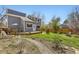 Landscaped backyard featuring a stone pathway, lawn, and well-maintained wooden deck at 3803 Dyanna Dr, Thornton, CO 80241