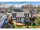 Backyard view of this home features a wooden deck with an outdoor seating area, a green lawn, and a privacy fence at 3803 Dyanna Dr, Thornton, CO 80241