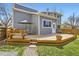 Backyard deck with seating and grill, and a view of the home's light-gray exterior at 3803 Dyanna Dr, Thornton, CO 80241
