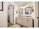 Bright bathroom with a double vanity sink, tile floor, and adjacent shower at 3803 Dyanna Dr, Thornton, CO 80241