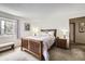 Bright bedroom featuring a wooden bed, plush carpet, and window seat for natural light at 3803 Dyanna Dr, Thornton, CO 80241