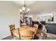 Inviting dining area with views into the living room showcasing hardwood floors and a fireplace at 3803 Dyanna Dr, Thornton, CO 80241