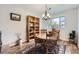 Cozy dining room featuring a round wooden table, vintage chairs, and a decorative bookshelf at 3803 Dyanna Dr, Thornton, CO 80241