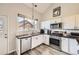 Clean kitchen with stainless steel appliances, white cabinets, and ample counter space at 3803 Dyanna Dr, Thornton, CO 80241