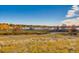 Tranquil park landscape featuring a path by a lake, autumn trees, and open fields at 3803 Dyanna Dr, Thornton, CO 80241