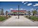 Modern train station with red roofing, pedestrian walkway, and manicured landscaping at 3803 Dyanna Dr, Thornton, CO 80241