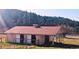This barn boasts multiple stalls with sliding doors, enhancing its functionality for livestock and horses at 3841 Myers Gulch Rd, Kittredge, CO 80457