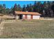 Rustic barn featuring an overhang for shelter, complete with gated entryways ideal for animals at 3841 Myers Gulch Rd, Kittredge, CO 80457