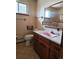 Functional bathroom with a unique pink sink, classic vanity, and a window providing natural light at 3841 Myers Gulch Rd, Kittredge, CO 80457