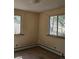 Bedroom features two windows and baseboard heaters at 3841 Myers Gulch Rd, Kittredge, CO 80457