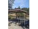 Wooden deck featuring a gazebo and table, perfect for outdoor entertaining with scenic views of the surrounding nature at 3841 Myers Gulch Rd, Kittredge, CO 80457