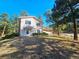 Charming two-story home featuring a covered entry, a wooden deck, and a tree-lined yard at 3841 Myers Gulch Rd, Kittredge, CO 80457