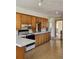 Functional kitchen with classic wood cabinets, electric range, and ample counter space, awaiting a modern refresh at 3841 Myers Gulch Rd, Kittredge, CO 80457