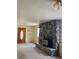 Living room with a stone fireplace and wood door at 3841 Myers Gulch Rd, Kittredge, CO 80457