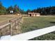 This property features a barn, a home, and a fenced-in pasture, creating a picturesque country setting at 3841 Myers Gulch Rd, Kittredge, CO 80457