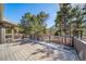 Spacious wooden deck surrounded by lush greenery, perfect for outdoor relaxation at 2049 Silverheels Dr, Larkspur, CO 80118