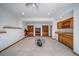 Spacious basement with a bar, built-in bookshelves, and a cozy fireplace at 2049 Silverheels Dr, Larkspur, CO 80118