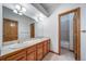 Well-lit bathroom features a double sink vanity with a tile countertop and an adjacent tiled shower/tub at 2049 Silverheels Dr, Larkspur, CO 80118