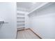 Bright white walk-in closet featuring multiple shelves and hanging rods for optimal storage at 2049 Silverheels Dr, Larkspur, CO 80118