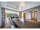 Open dining area with hardwood floors, stone accents, and contemporary lighting fixtures at 2049 Silverheels Dr, Larkspur, CO 80118