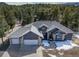 Charming home featuring a stone facade, three-car garage, and a well-maintained yard at 2049 Silverheels Dr, Larkspur, CO 80118