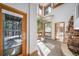 Welcoming foyer with a stone fireplace, lots of windows, and a view of the surrounding forest at 2049 Silverheels Dr, Larkspur, CO 80118