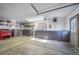 Attached garage featuring built-in cabinets and ample space for storage and hobbies at 2049 Silverheels Dr, Larkspur, CO 80118