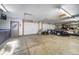 Large garage featuring storage cabinets, garage doors, and ample space for hobbies and recreation at 2049 Silverheels Dr, Larkspur, CO 80118