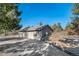 Detached garage with two bays and an extra door; surrounded by mature trees at 2049 Silverheels Dr, Larkspur, CO 80118