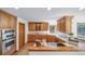 Bright kitchen featuring wooden cabinetry, stainless steel appliances, and lots of counter space at 2049 Silverheels Dr, Larkspur, CO 80118