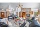 Expansive living space with a stone fireplace, comfortable seating, and natural lighting at 2049 Silverheels Dr, Larkspur, CO 80118