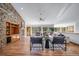 Spacious living room featuring hardwood floors, a stone fireplace, and an open layout at 2049 Silverheels Dr, Larkspur, CO 80118
