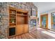 Inviting living room showcasing a stone fireplace and custom-built wooden shelving at 2049 Silverheels Dr, Larkspur, CO 80118
