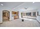 Bright living room features a wet bar, natural light, and neutral carpet at 2049 Silverheels Dr, Larkspur, CO 80118
