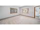 Spacious living room with large windows providing natural light and scenic views, leading to the hallway at 2049 Silverheels Dr, Larkspur, CO 80118