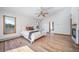 Spacious main bedroom with hardwood floors, large windows, and a ceiling fan at 2049 Silverheels Dr, Larkspur, CO 80118