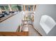 Unique view of the staircase leading up from the first floor with lots of natural light from nearby windows at 2049 Silverheels Dr, Larkspur, CO 80118