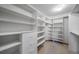 Walk-in closet with custom shelving, drawers, and ample storage space for clothes and accessories at 2049 Silverheels Dr, Larkspur, CO 80118