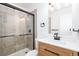 Beautiful bathroom features a large tile shower with glass door, modern lighting, and stylish vanity with light wood accents at 3035 Oneal Pkwy # 20V, Boulder, CO 80301