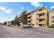Exterior view of a multi-story apartment building featuring balconies and a spacious parking lot on a sunny day at 3035 Oneal Pkwy # 20V, Boulder, CO 80301