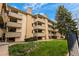 A multi-story apartment building featuring balconies, well-maintained lawns, and beautiful landscaping on a sunny day at 3035 Oneal Pkwy # 20V, Boulder, CO 80301