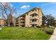 Attractive multi-story apartment building featuring balconies, well-maintained lawns, and beautiful landscaping on a sunny day at 3035 Oneal Pkwy # 20V, Boulder, CO 80301