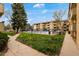 Apartment complex featuring a fenced-in pool area, mature trees, and a walking path at 3035 Oneal Pkwy # 20V, Boulder, CO 80301