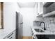 The updated kitchen features stainless appliances, white cabinets, and granite countertop at 3035 Oneal Pkwy # 20V, Boulder, CO 80301