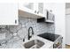 A close up of the kitchen sink, backsplash, and stainless steel oven at 3035 Oneal Pkwy # 20V, Boulder, CO 80301