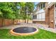 Spacious backyard with trampoline, swing chair and stone features that create a fun and relaxing outdoor space at 7703 S Grape Ct, Centennial, CO 80122
