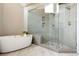 Stylish bathroom with a soaking tub, a glass-enclosed shower, and sleek tile work throughout at 7703 S Grape Ct, Centennial, CO 80122