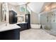 Luxury bathroom features dual vanities, a soaking tub, a glass-enclosed shower, and modern fixtures at 7703 S Grape Ct, Centennial, CO 80122
