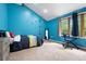 Playful bedroom boasting a climbing wall, blue accent wall, and bright natural light at 7703 S Grape Ct, Centennial, CO 80122